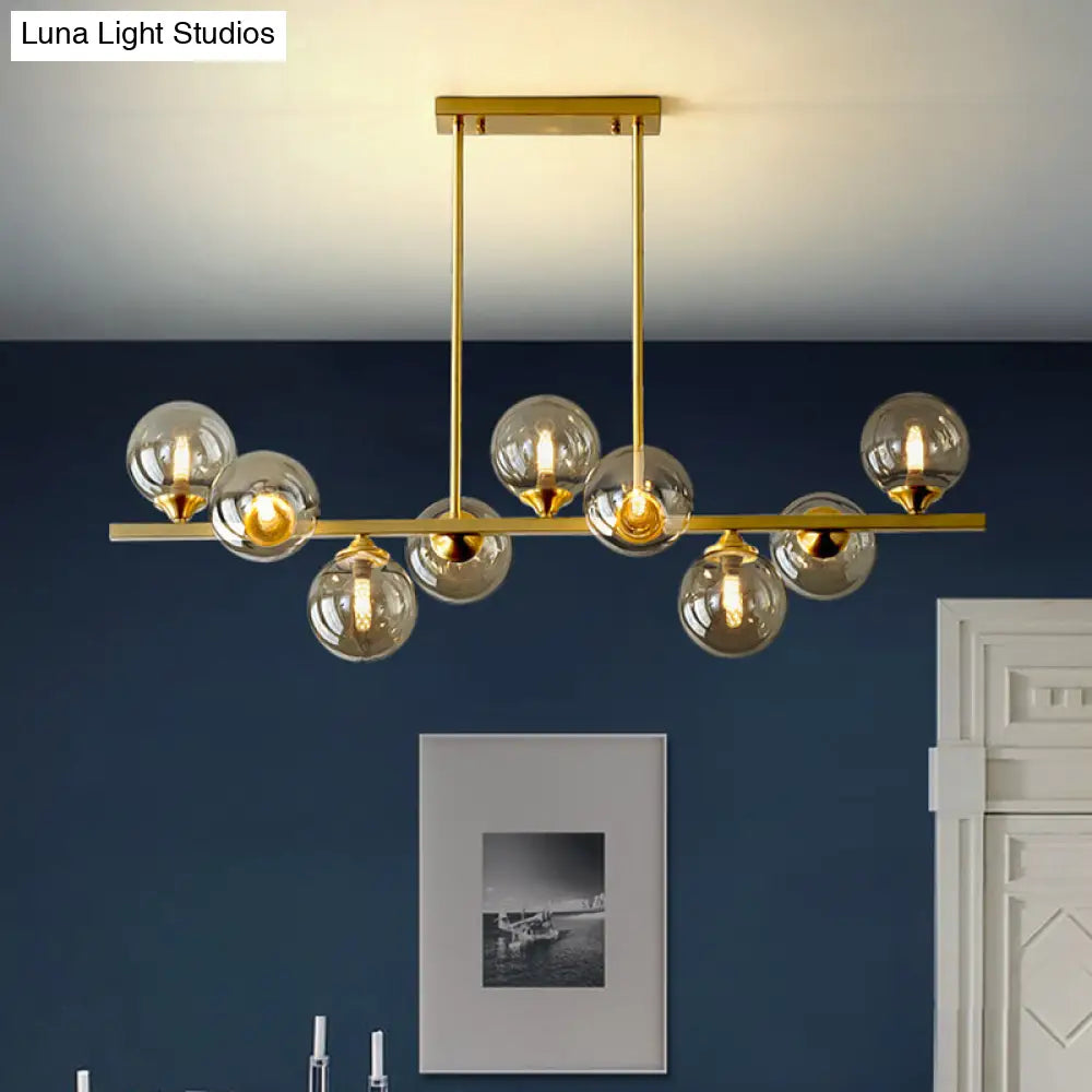DecorBites™ Mid-Century Modern Gold Metal Pendant with Spherical Amber Glass - Island Ceiling Light for Dining Table