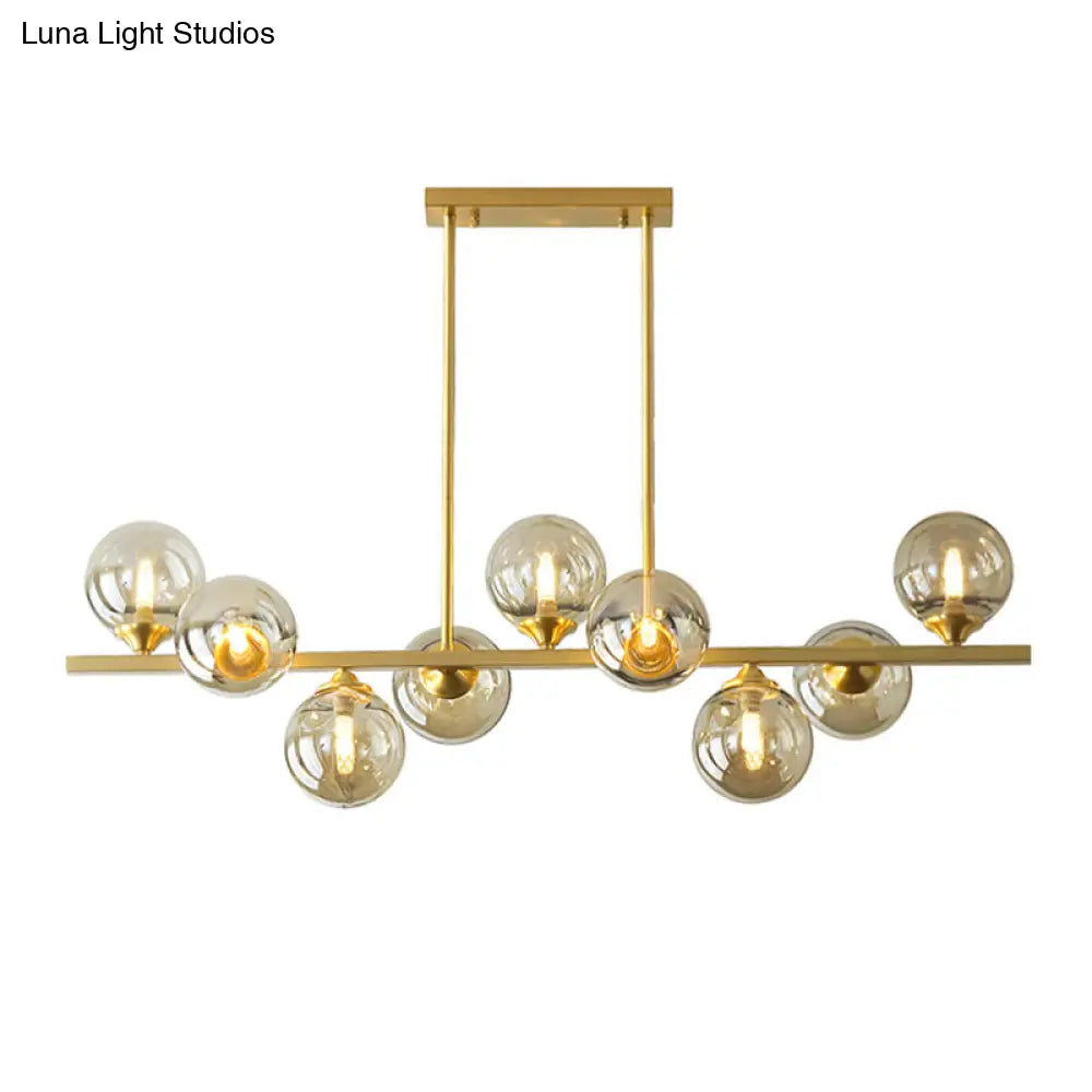 DecorBites™ Mid-Century Modern Gold Metal Pendant with Spherical Amber Glass - Island Ceiling Light for Dining Table